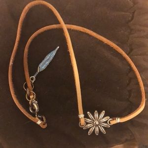 Tan leather choker with silver flower.